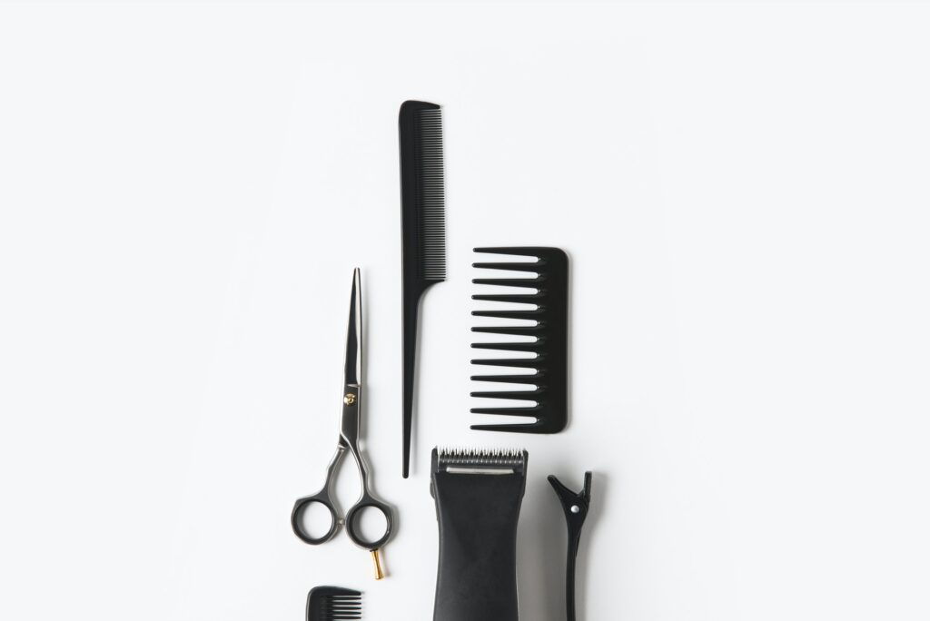 flat lay with hair machine and hairdressing tools, on white